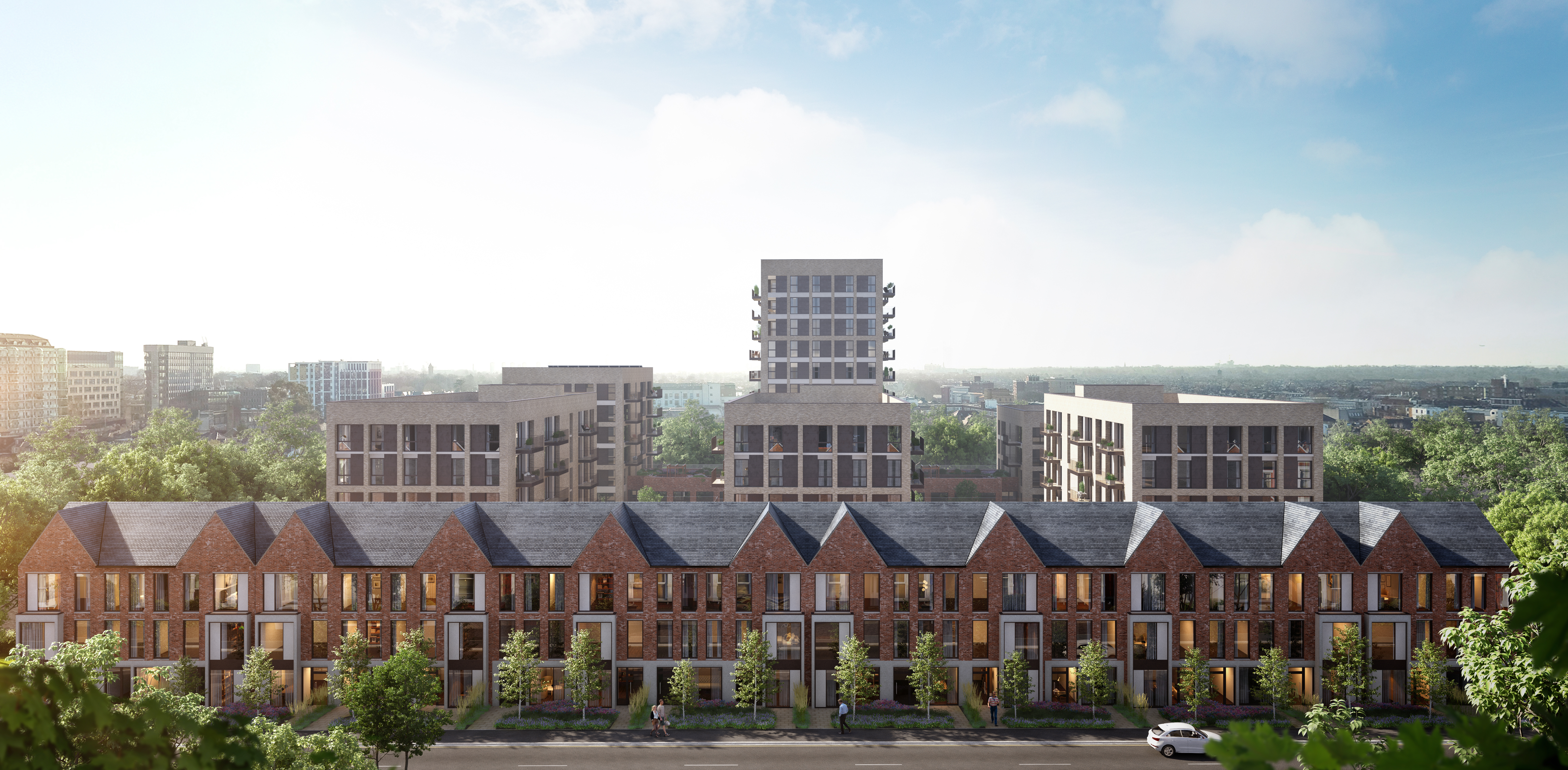 Weest Ealing - treet-level view of modern townhouses with brick facades and pointed roofs, with taller residential buildings in the background, surrounded by greenery.